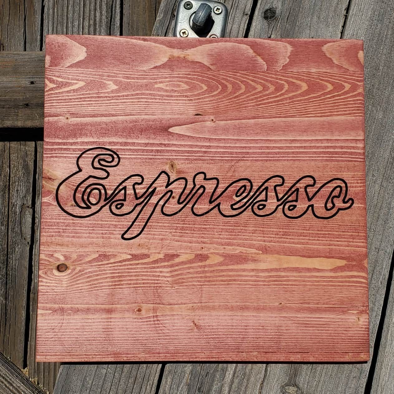 Red stained wooden sign with the word