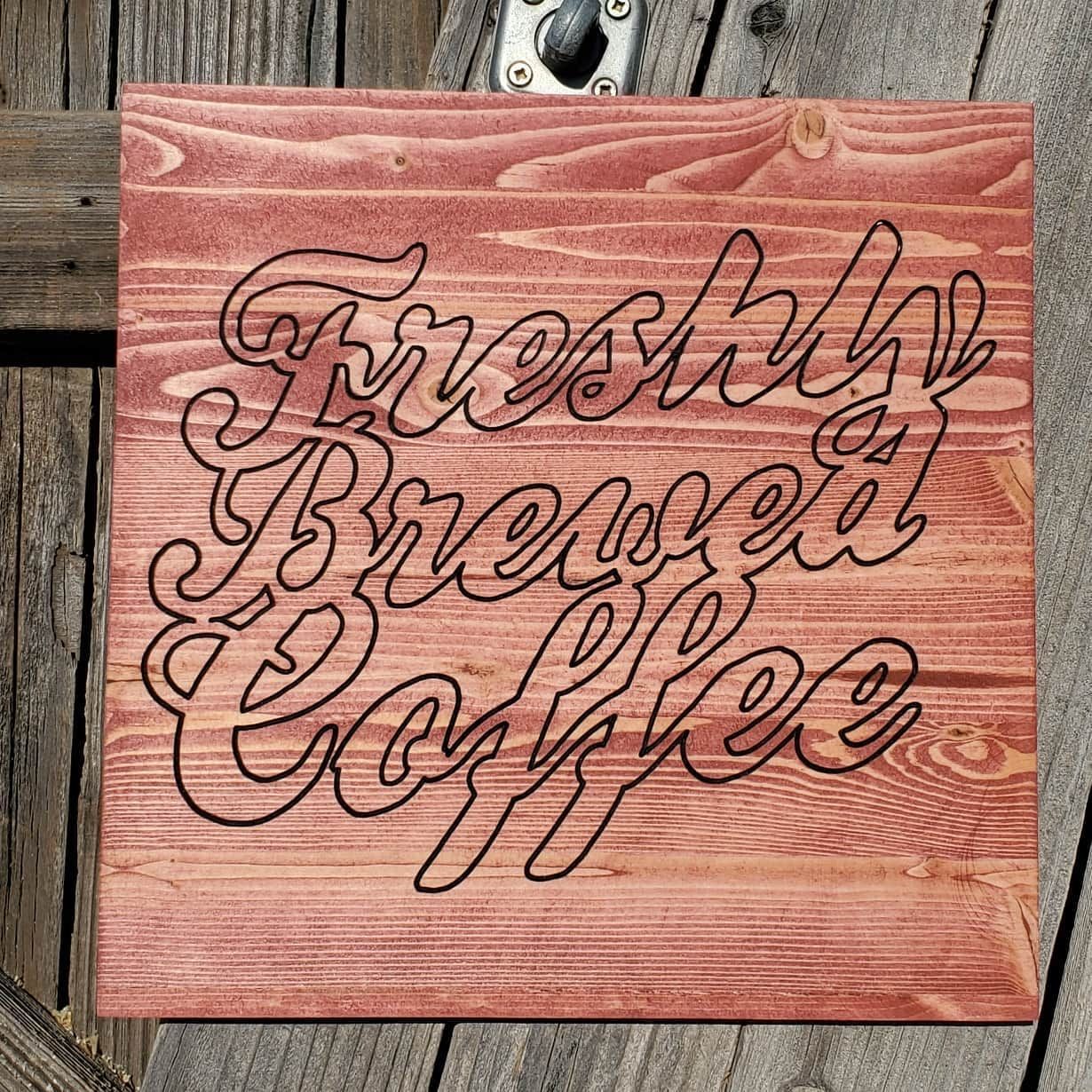 Wooden sign with etched text: