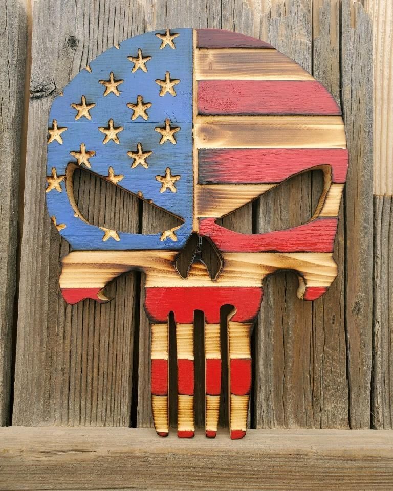 Wooden skull carving with American flag design.