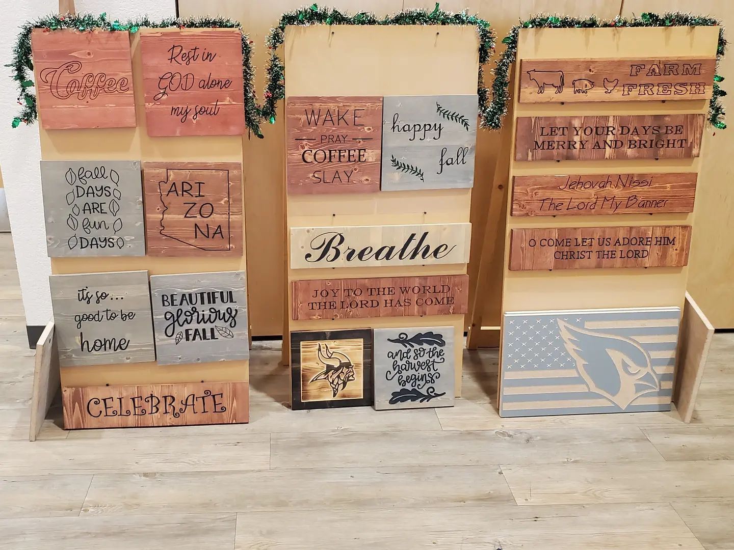 Bricks with inspirational quotes and a painted American flag displayed on wooden easels.