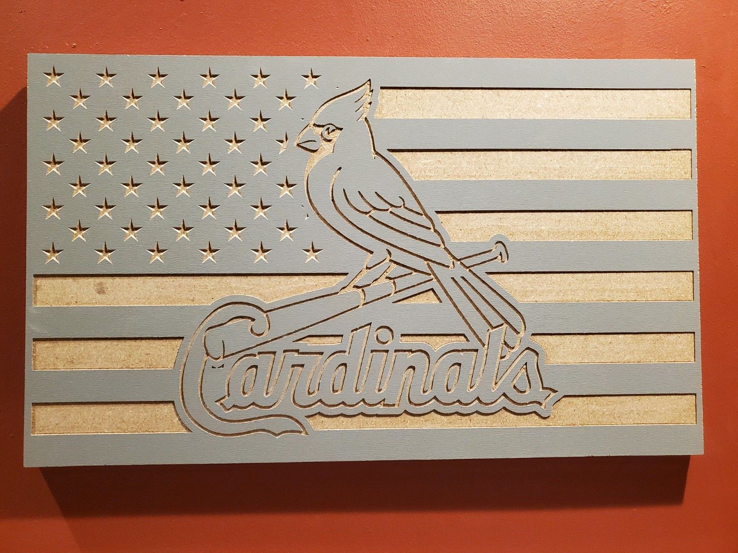 Wooden American flag with St. Louis Cardinals logo cut out. Grey and tan colors.