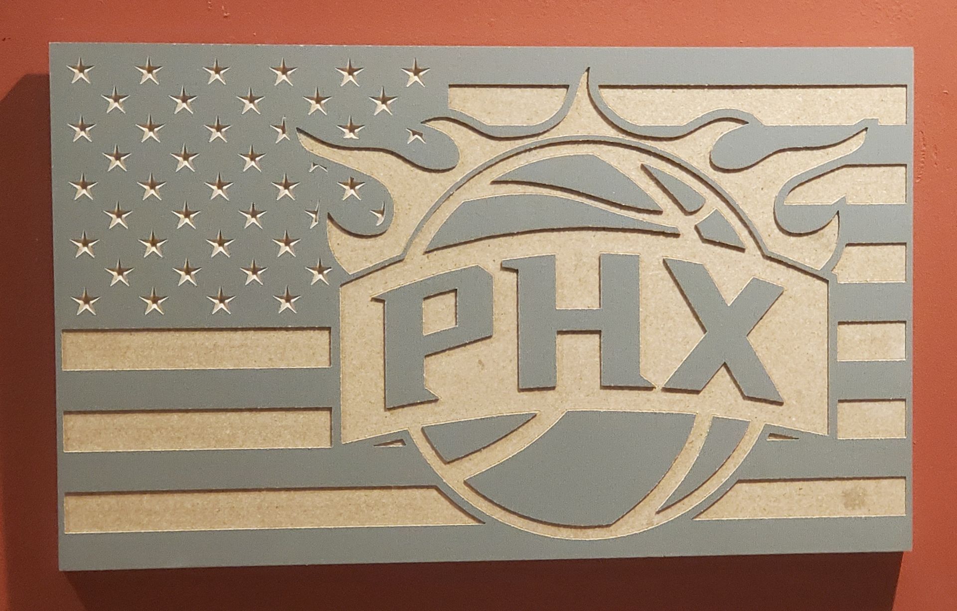 Wooden carving: Phoenix Suns logo over US flag, gray and natural wood colors.