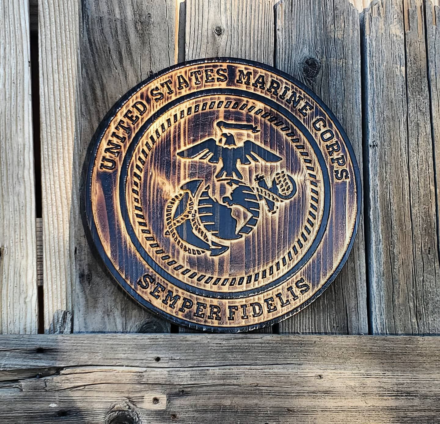 Wooden plaque with United States Marine Corps emblem.