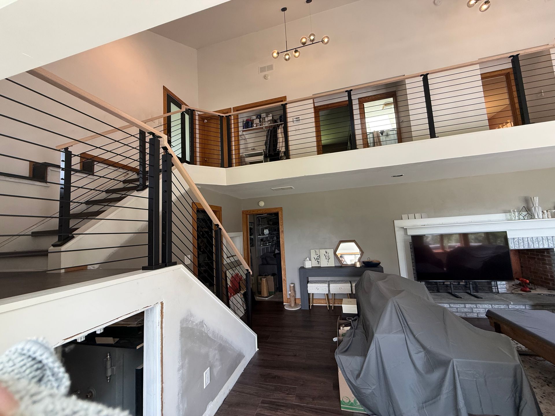 energy-efficient windows clermont Empty, gray-painted, triangular under-stair storage space with wood-look flooring and white trim.