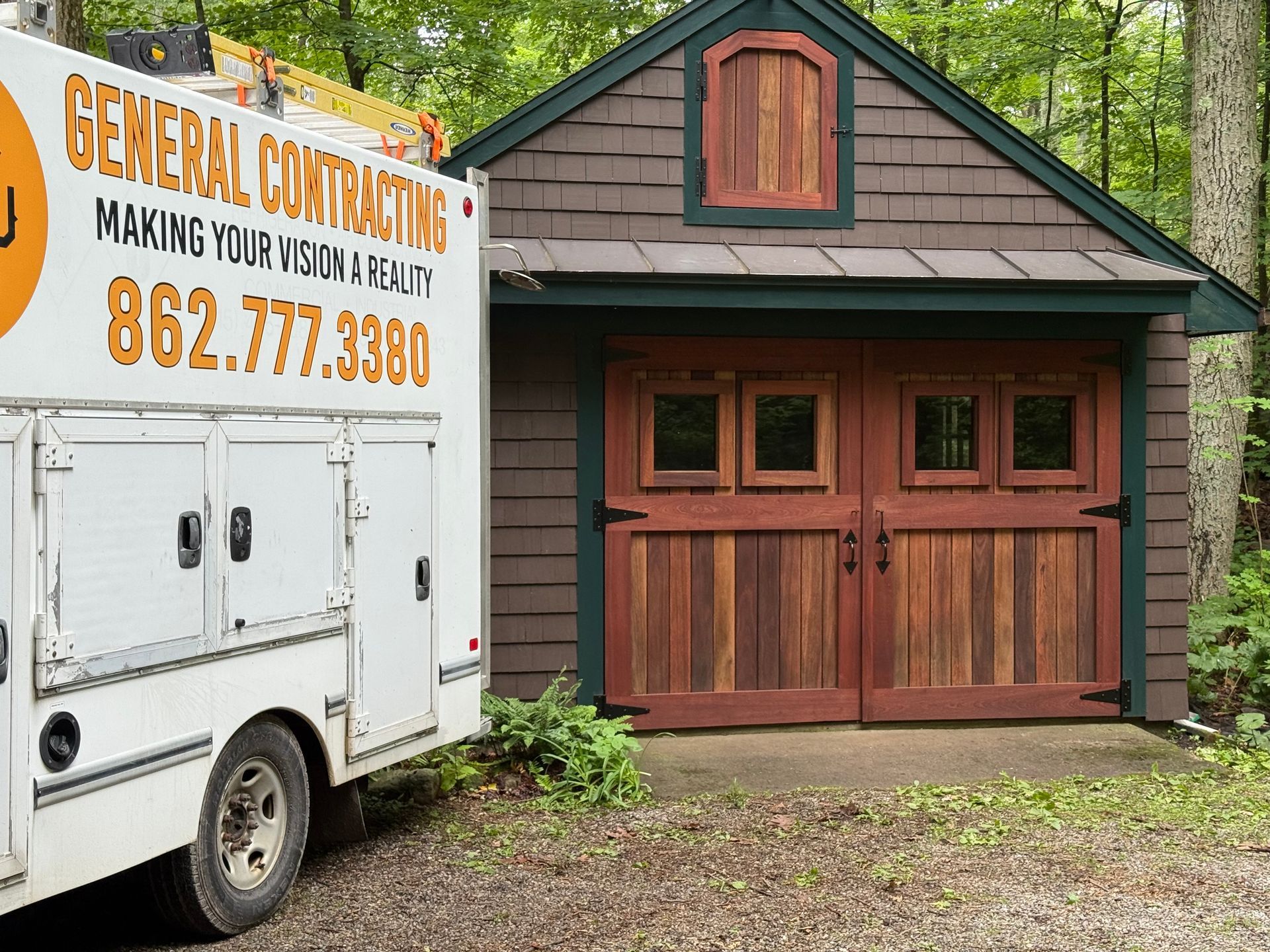 White work truck next to a brown shed with red doors; 