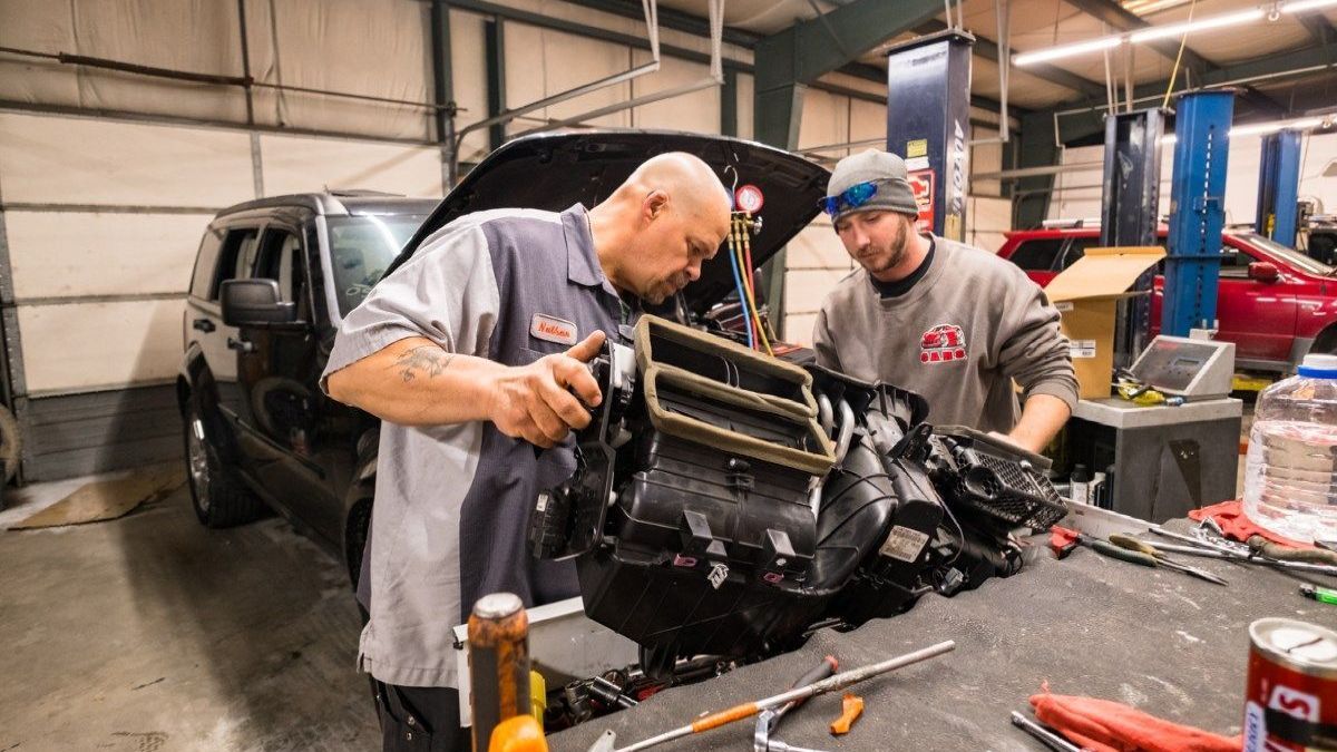 two men working on a car