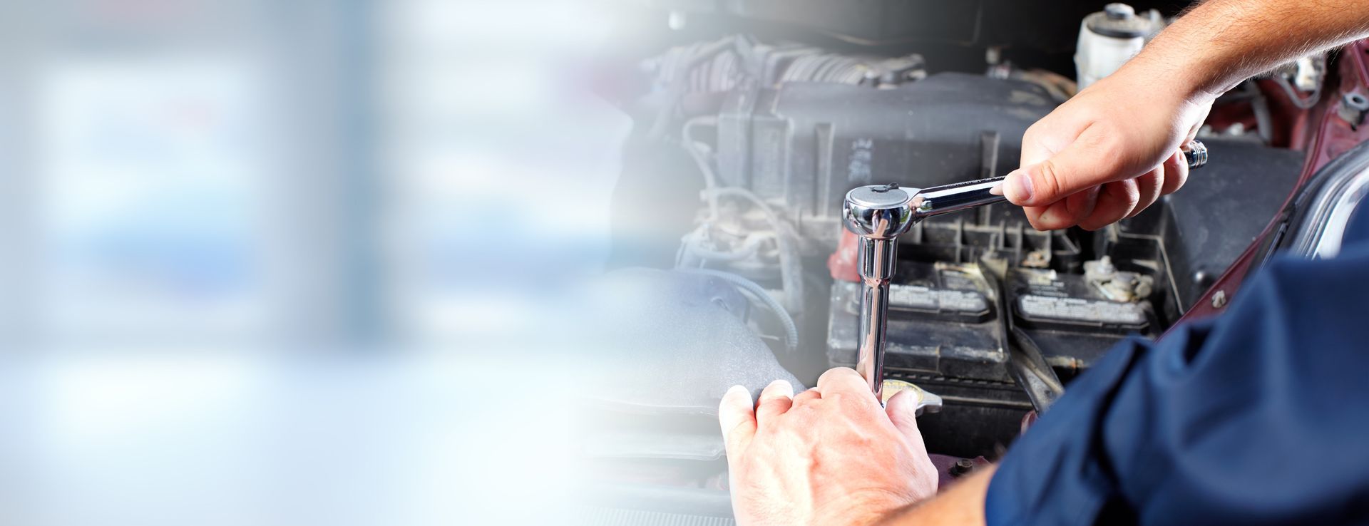 a man is working on a car with a wrench