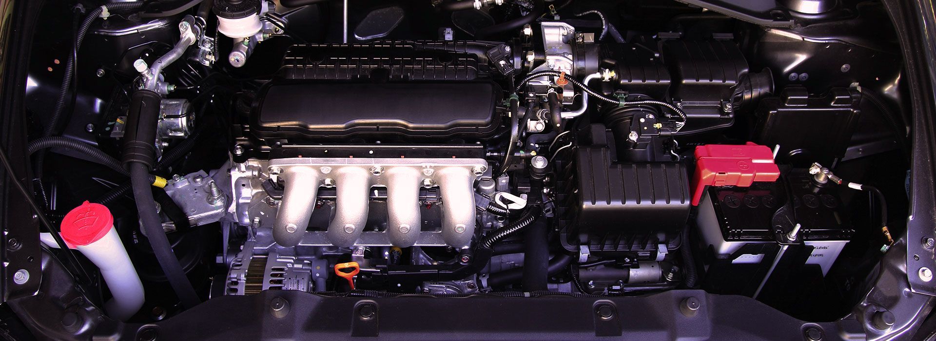 a close up of a car engine with a red cap on it
