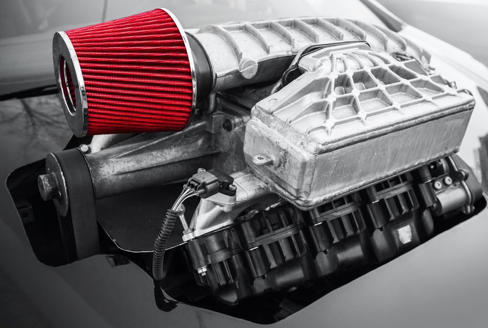 A Black And White Photo Of A Car Engine With A Red Filter Attached To It — Hastings Diesel Service In Laurieton, NSW