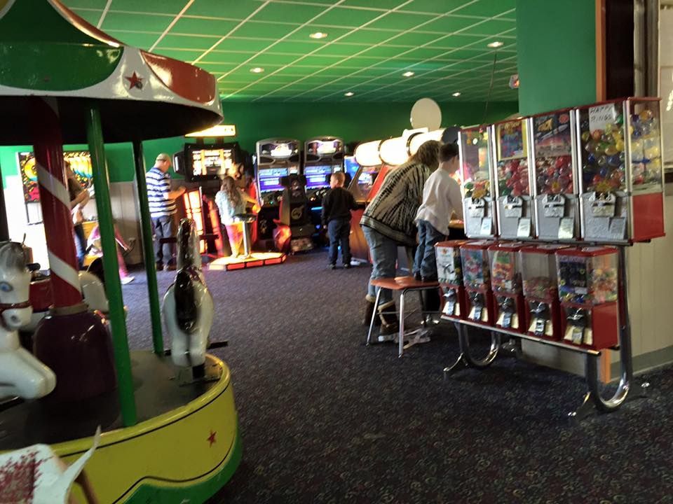 People are playing arcade games in an amusement park