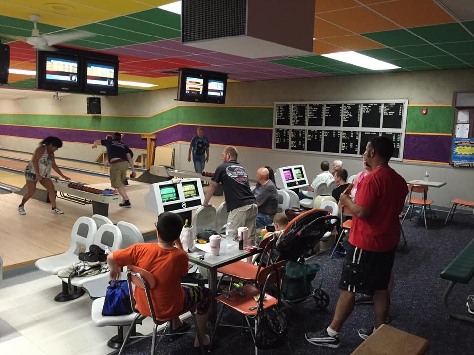 A group of people are playing bowling in a bowling alley.