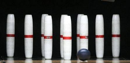 A bowling alley with bowling pins and a bowling ball