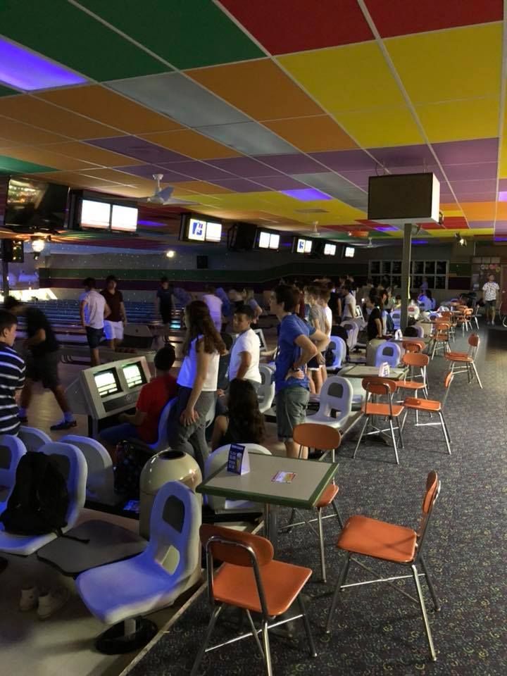 A group of people are playing bowling in a bowling alley.