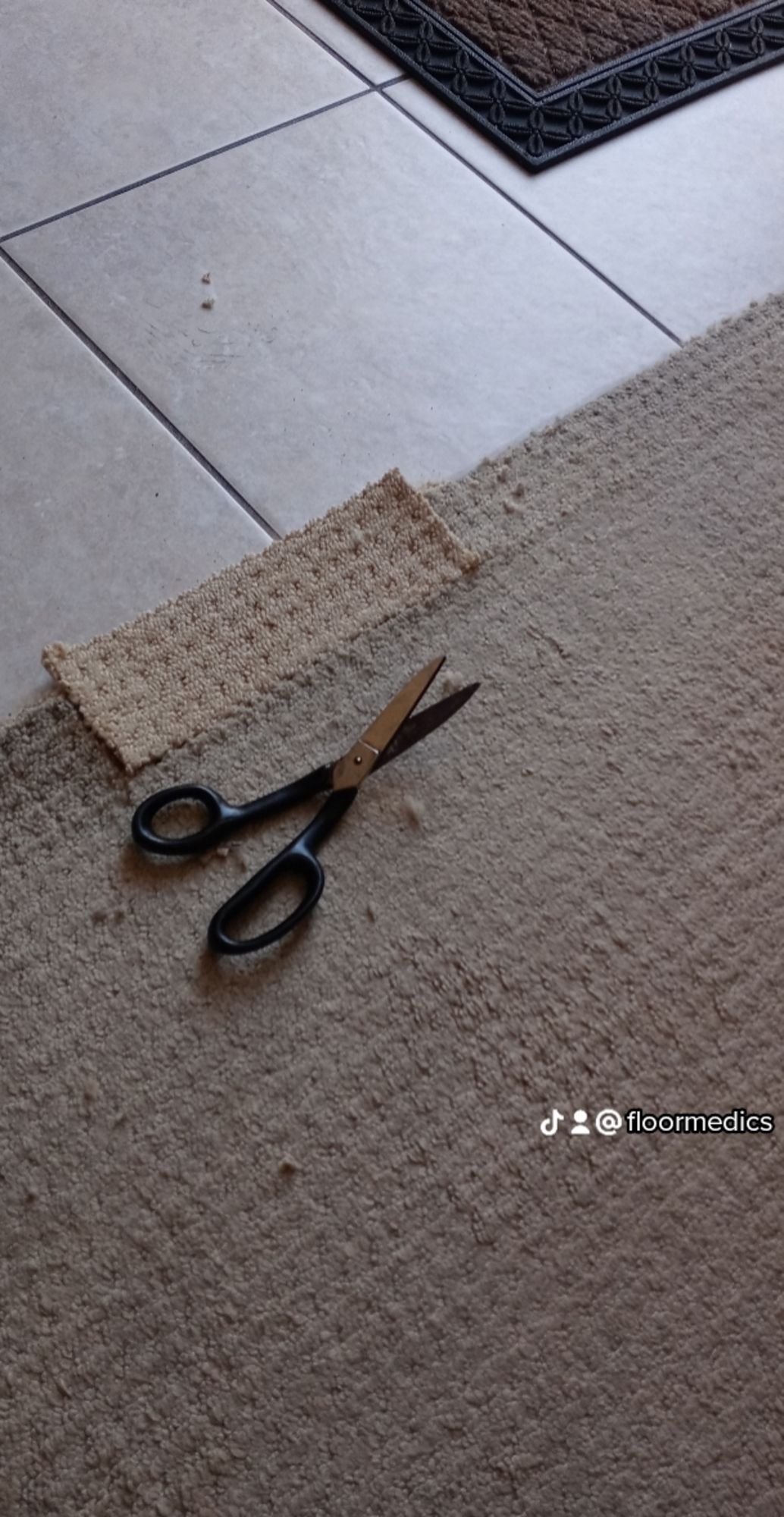 A pair of scissors laying on top of a carpet