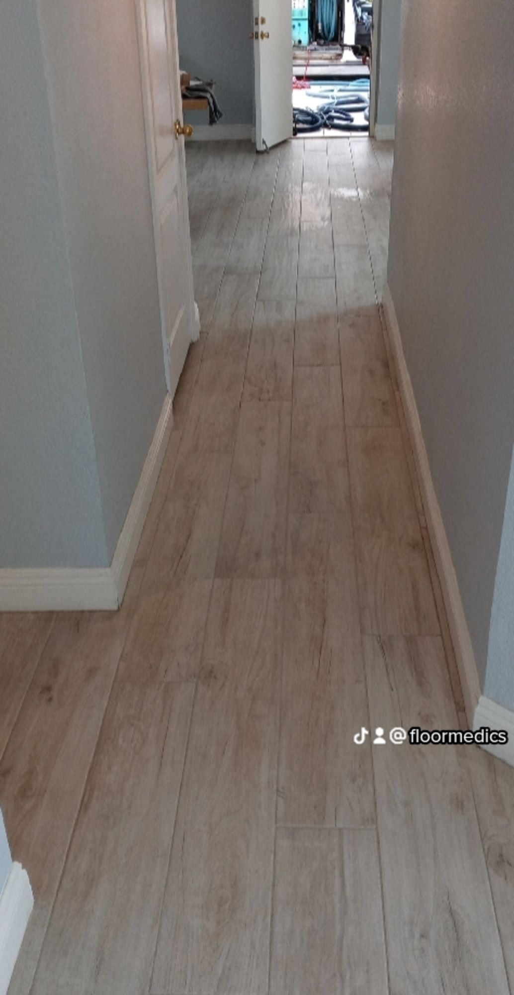 A hallway with a wooden floor in a house.