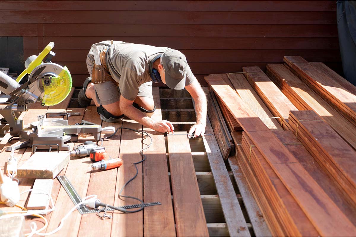 A Carpenter Building A Deck