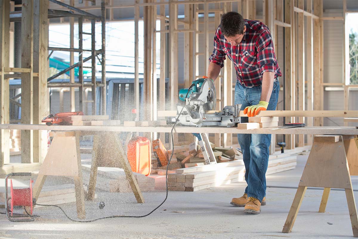 A Carpenter Building A Wood Stud Wall