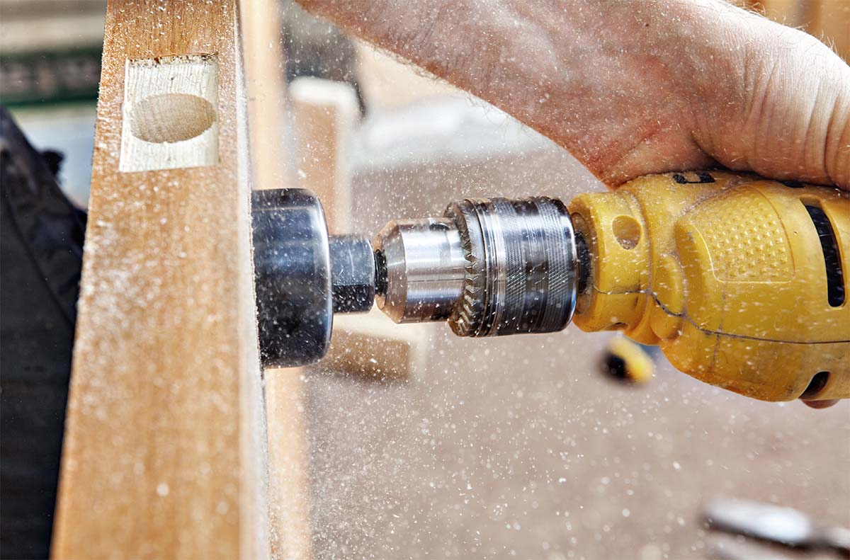 Carpenter Installing A Door Handle