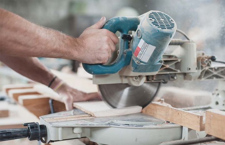 Carpenter Using A Compound Mitre Saw