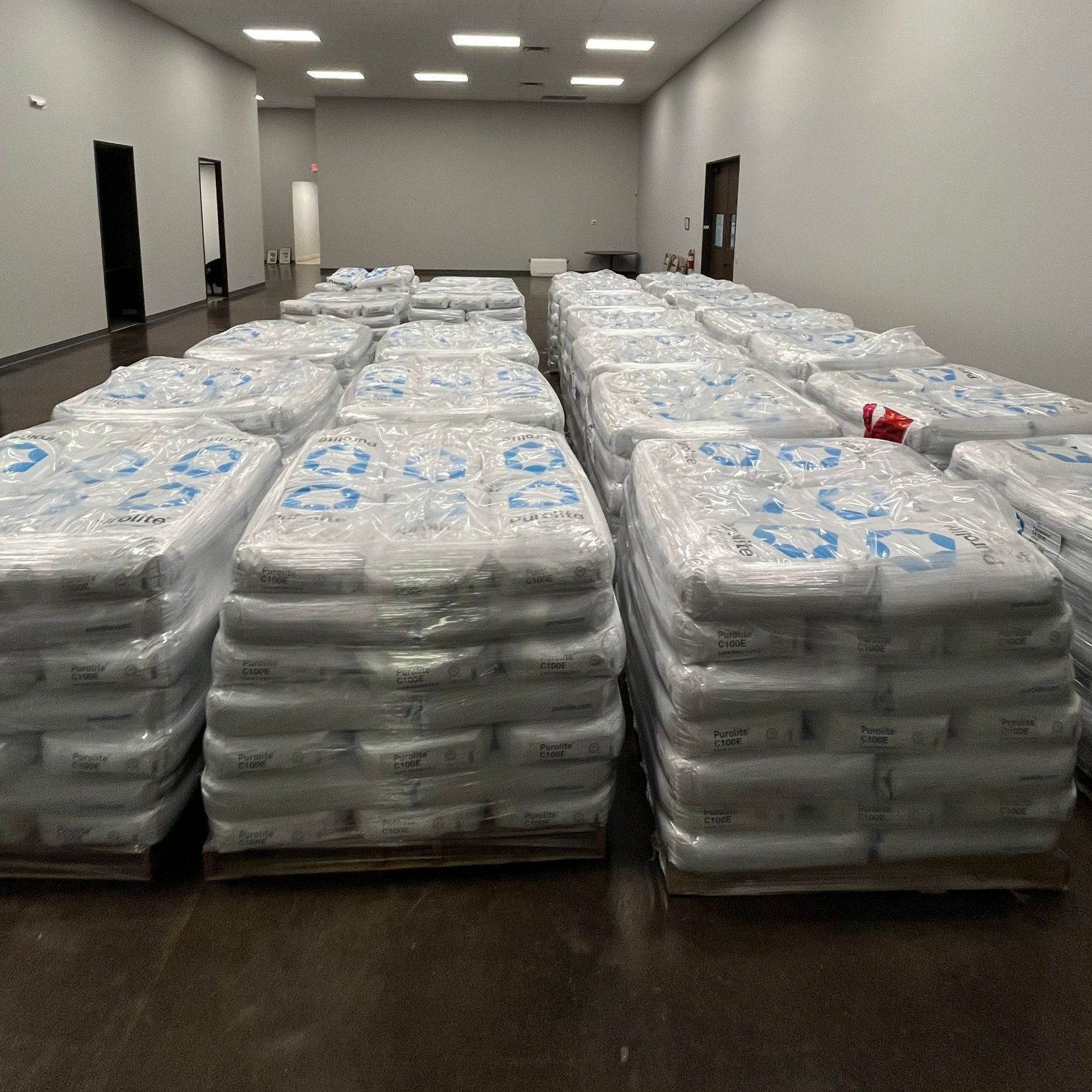 A warehouse filled with lots of Purolite Resin bags with numbers on them