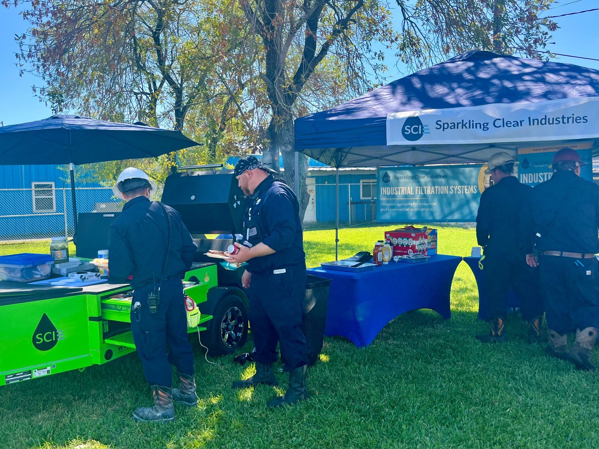 Plant Workers at Sparkling Clear's Green Monster Cook Trailer on a beautiful, sunny day.