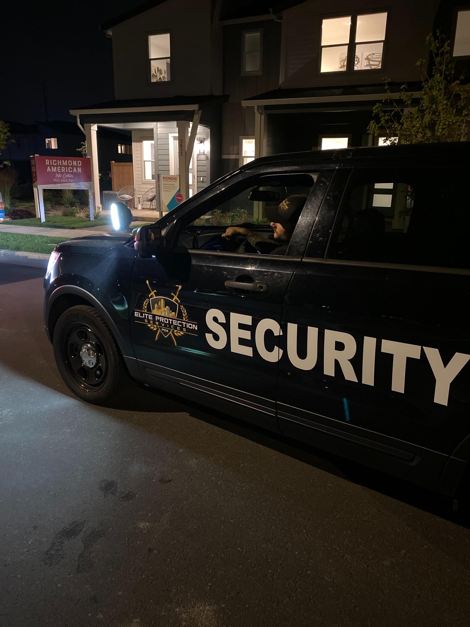 Security vehicle parked outside a dimly lit building at night