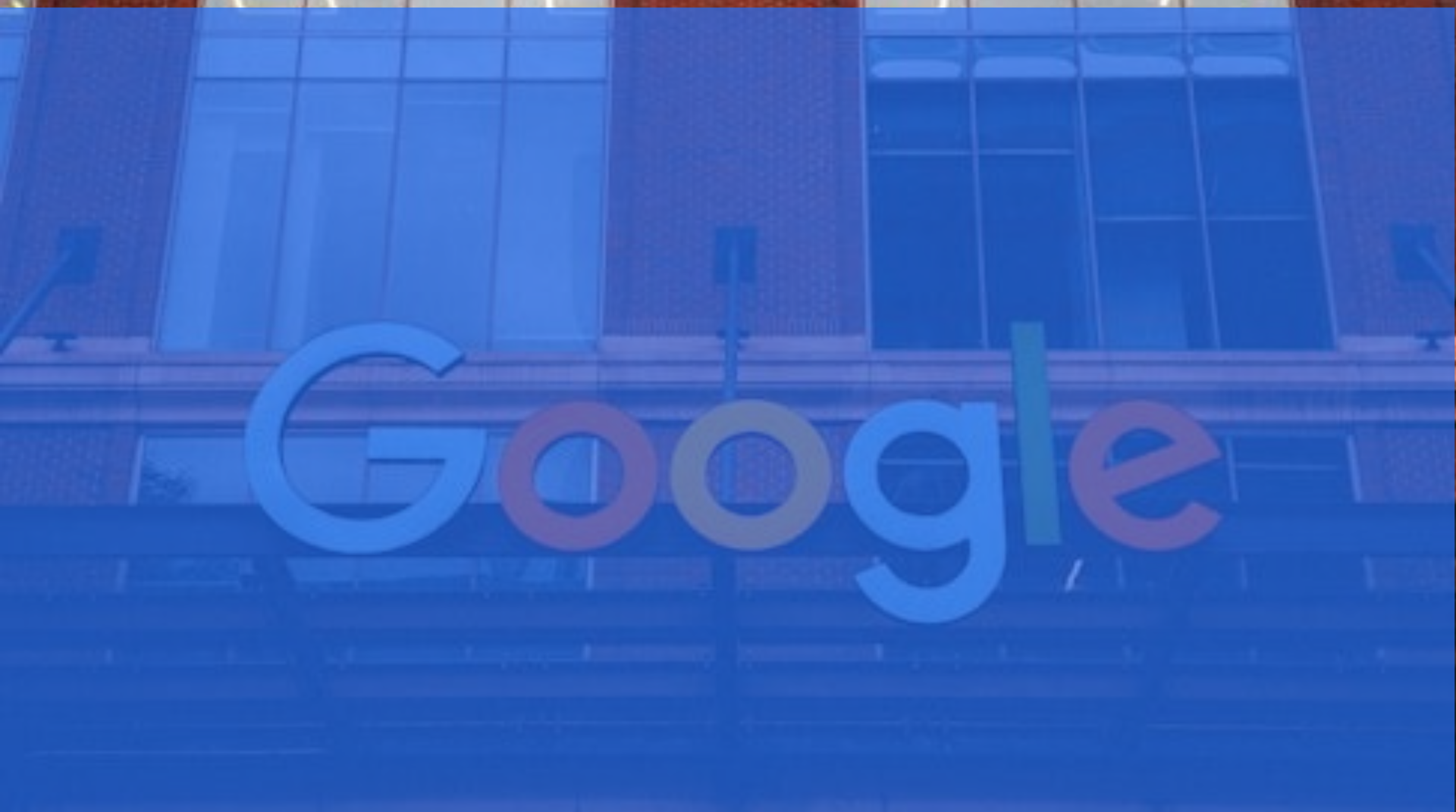 Google logo on a glass building facade with a blue tint