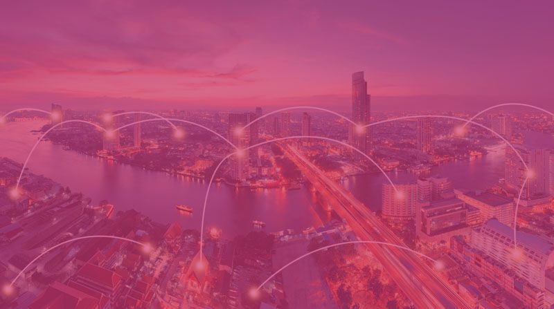 Pink-tinted aerial cityscape with glowing network lines connecting buildings over water