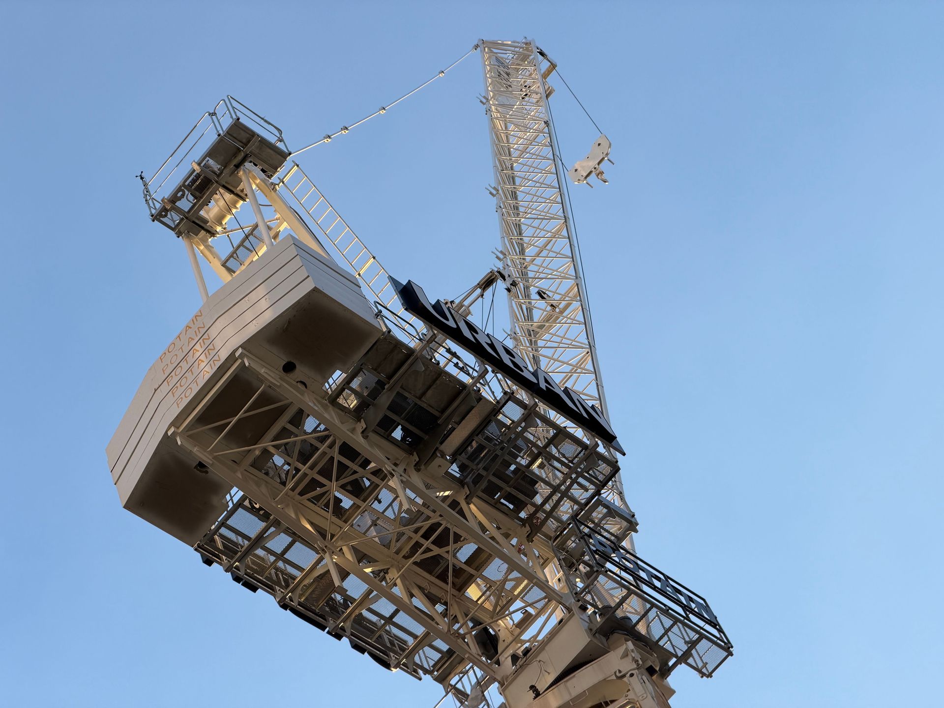 Large industrial drilling rig tilted against a clear blue sky