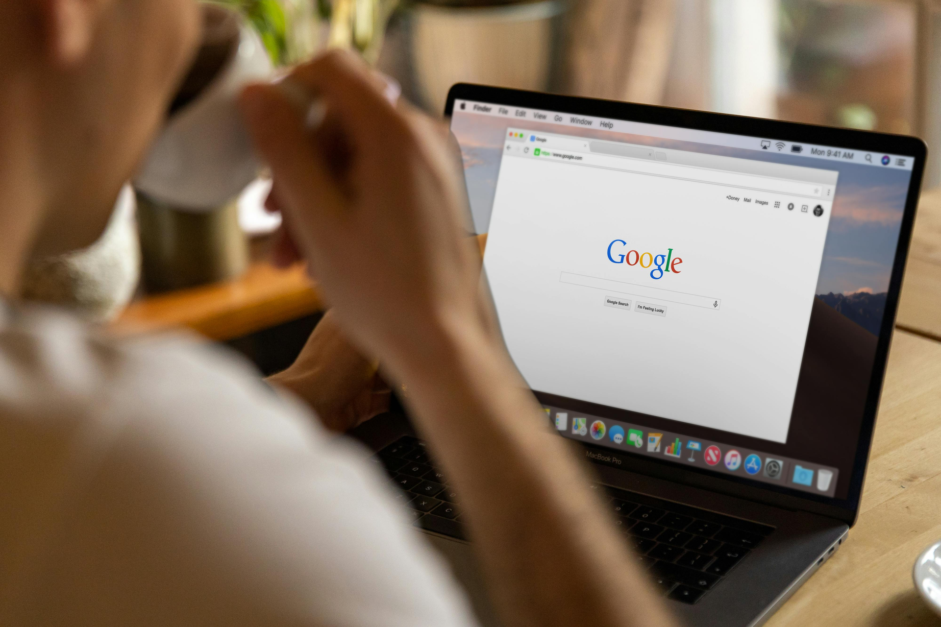 Person using a laptop with Google open on the screen