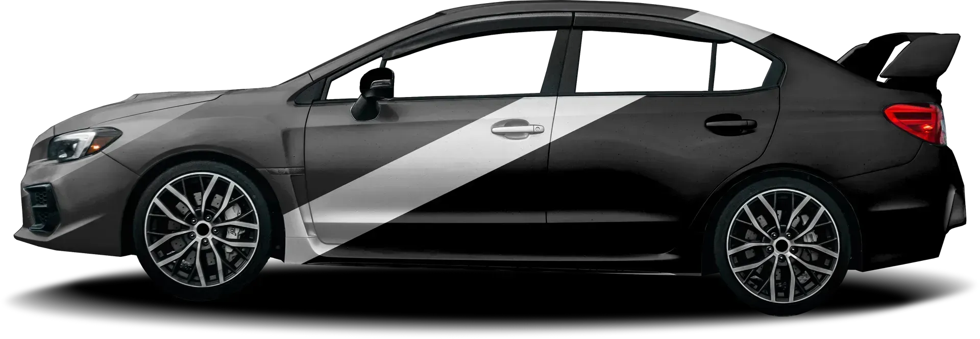 Side view of a black and charcoal Subaru WRX with a diagonal white stripe and a rear spoiler.