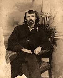 Alfred packer sits in a chair
