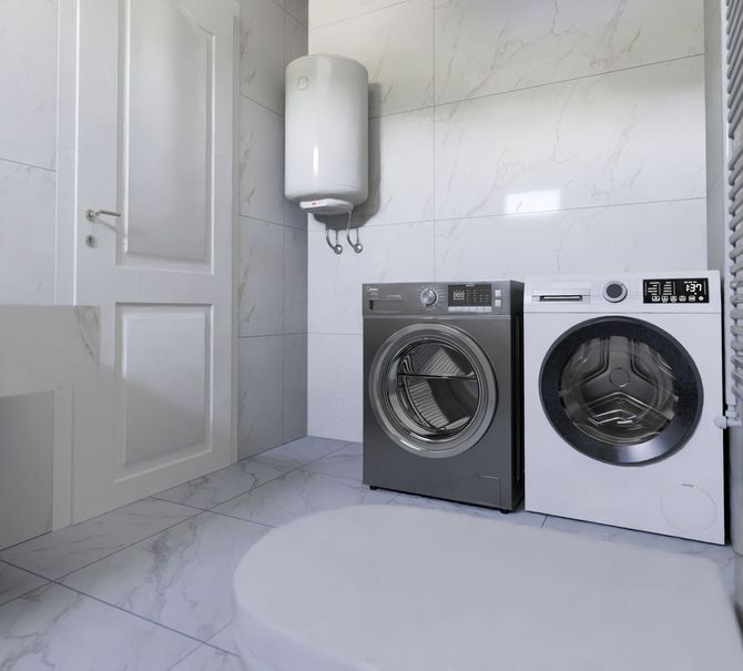 Laundry room with two front-loading washing machines, white walls, a door, and a wall-mounted water heater.