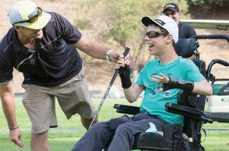 CAA student playing golf from a wheel chair