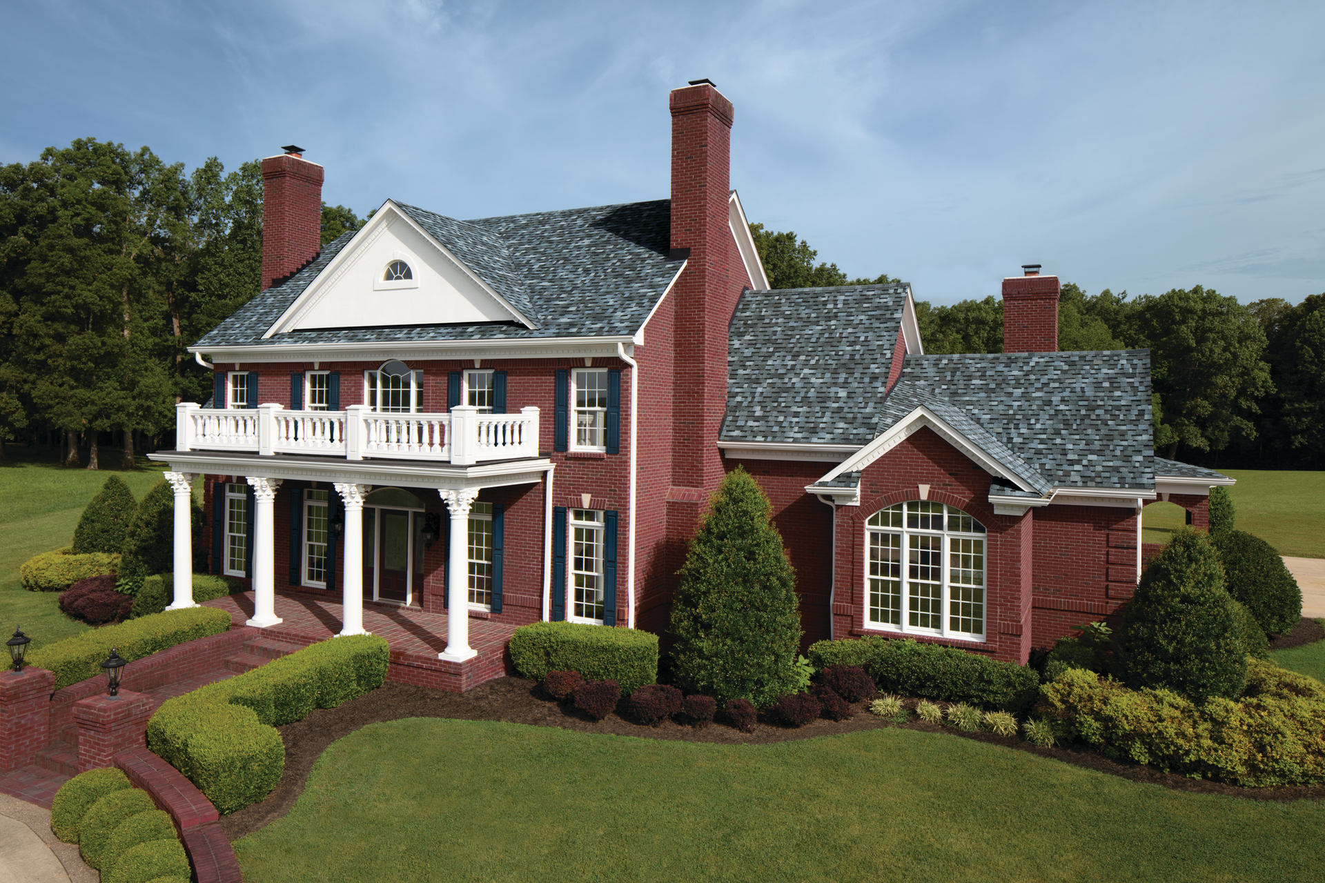 A large red brick house with a blue roof