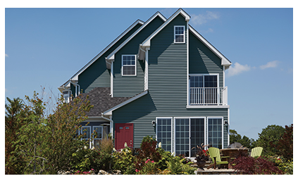A large house with a blue siding and white trim