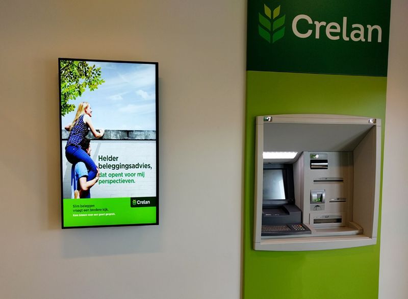 a crelan sign hangs above an atm machine