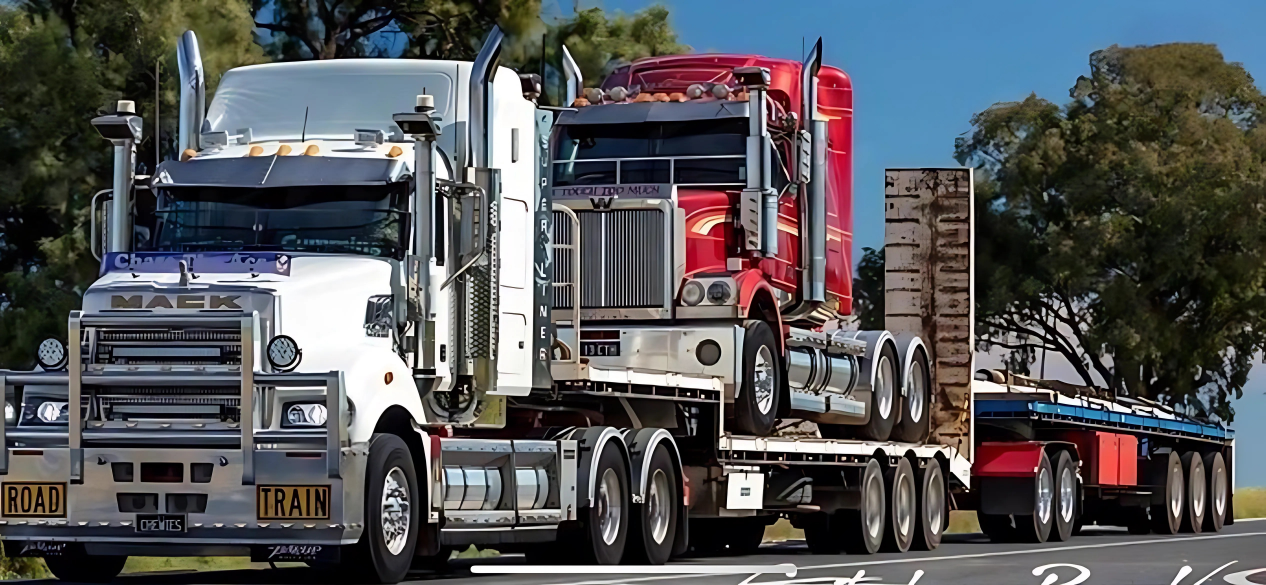 White semi-truck with two trailers loaded with gravel on dirt, parked on a sunny day — Chewies Tipper Hire & Haulage in Gracemere, QLD