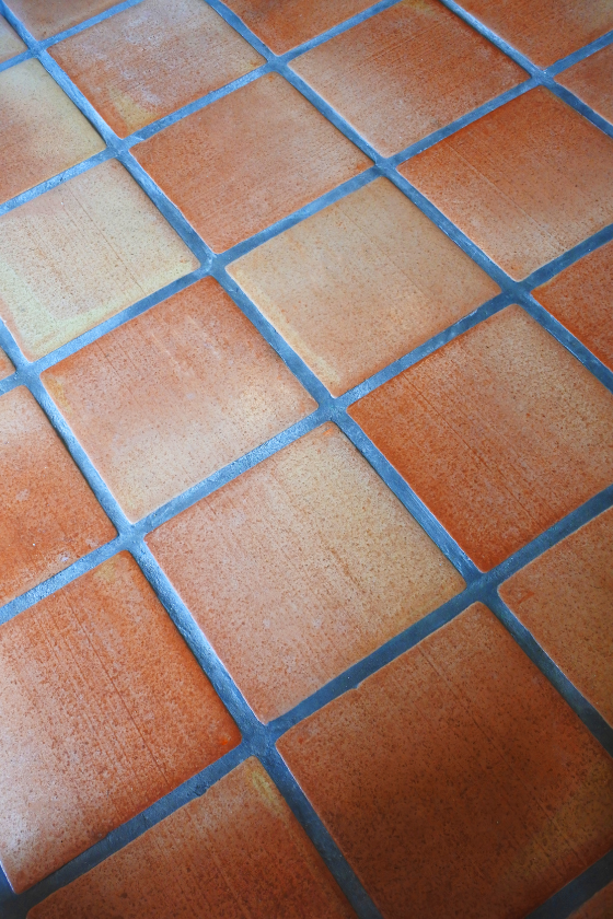 A close up of a tiled floor with a checkered pattern.