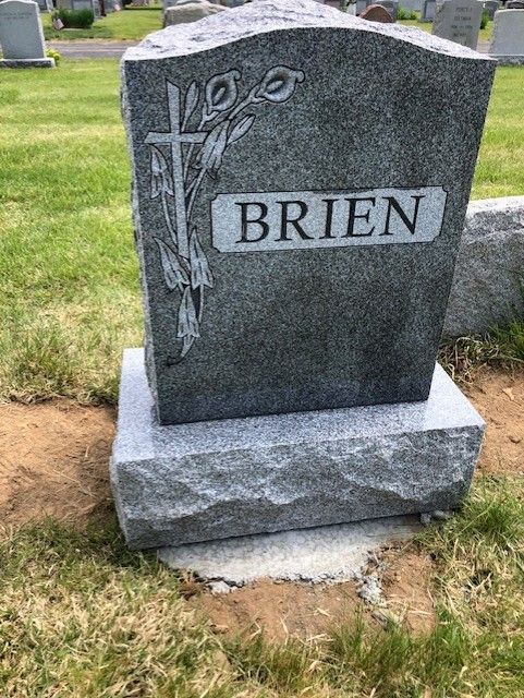 A gray granite headstone inscribed with 