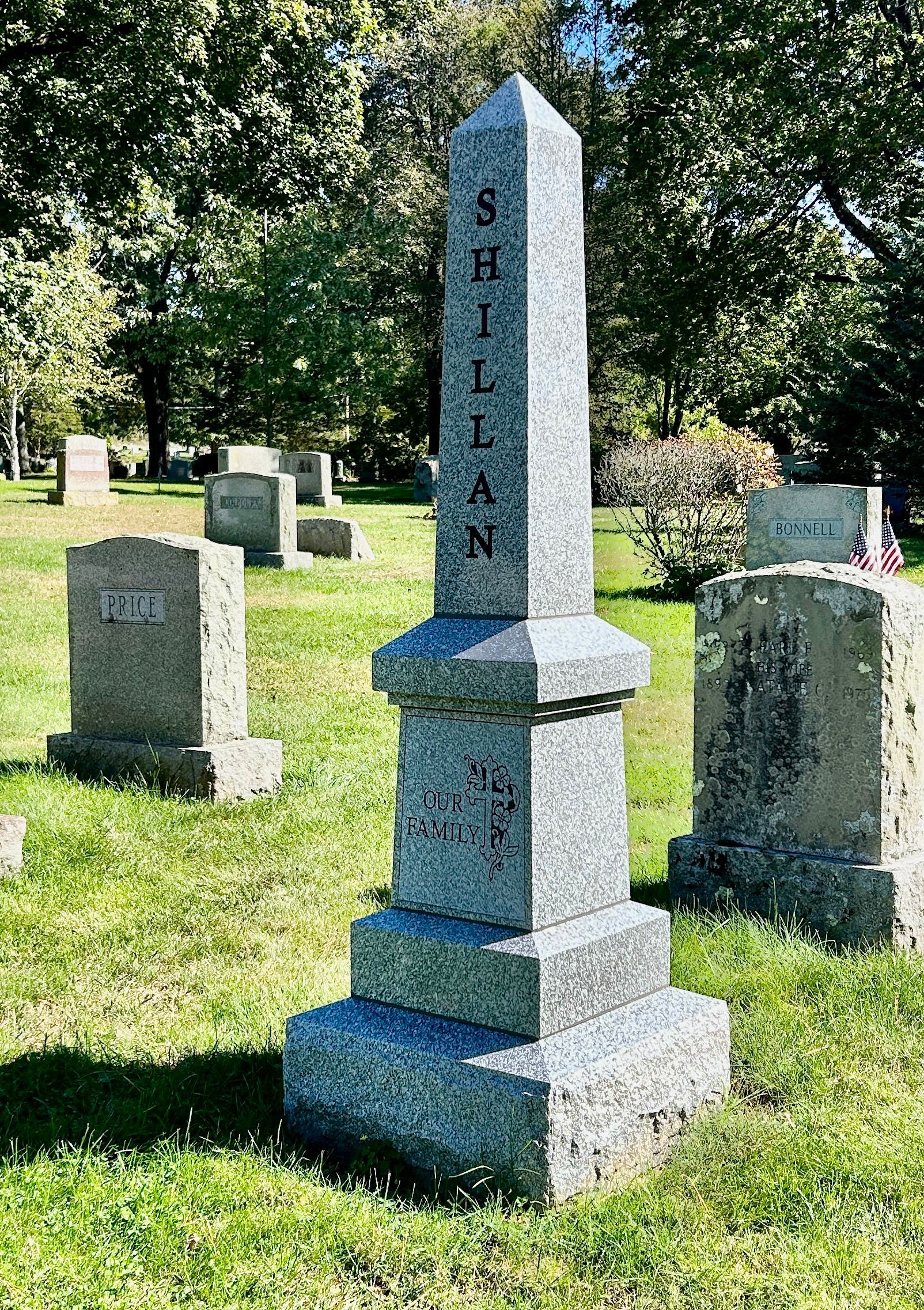 A grey stone obelisk monument marked 