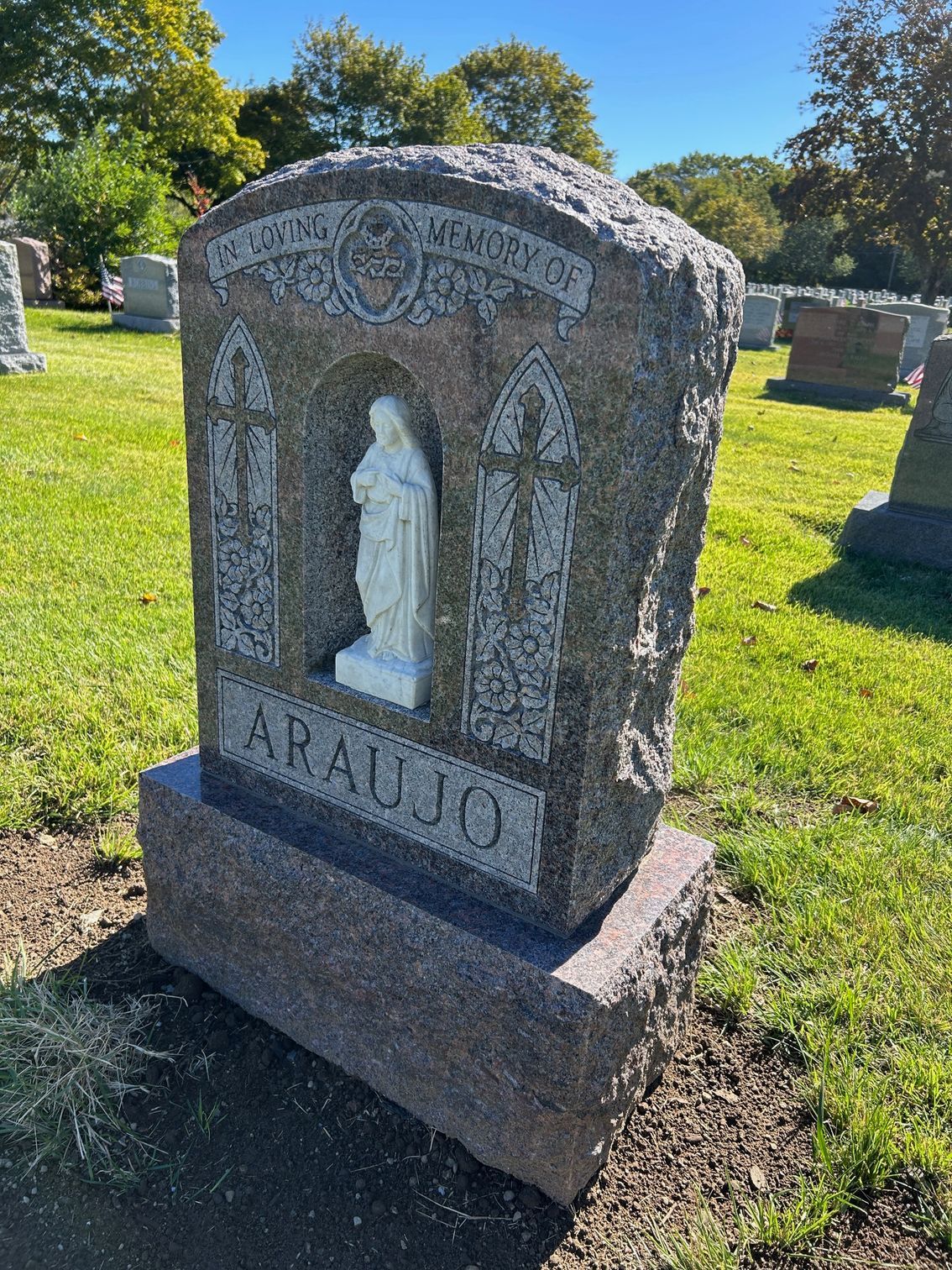 A granite tombstone marked 