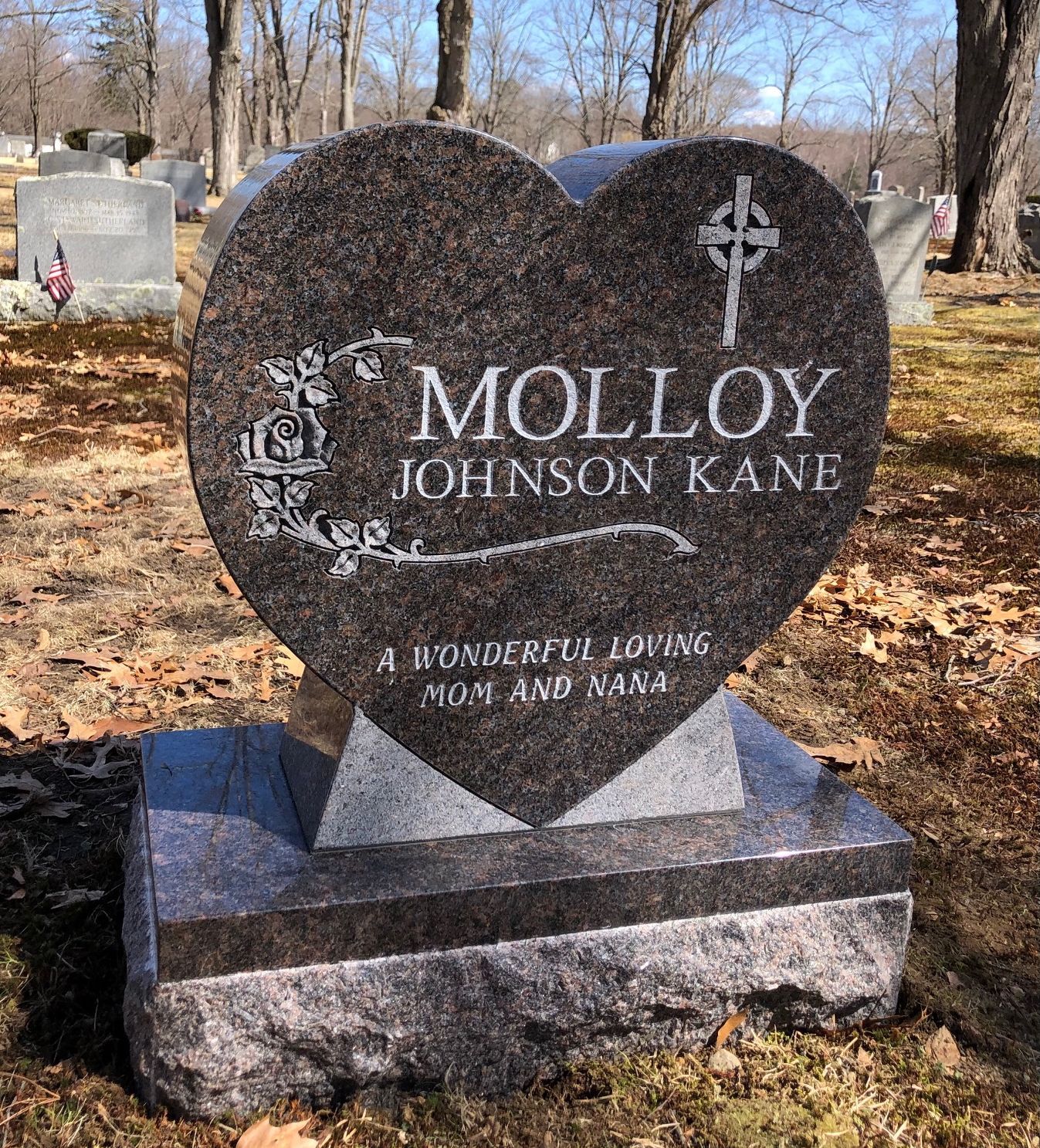 Heart-shaped granite tombstone in a cemetery with 