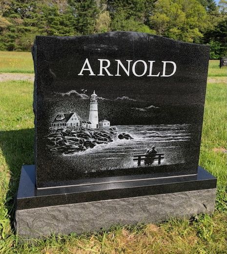 A black granite headstone with the name 