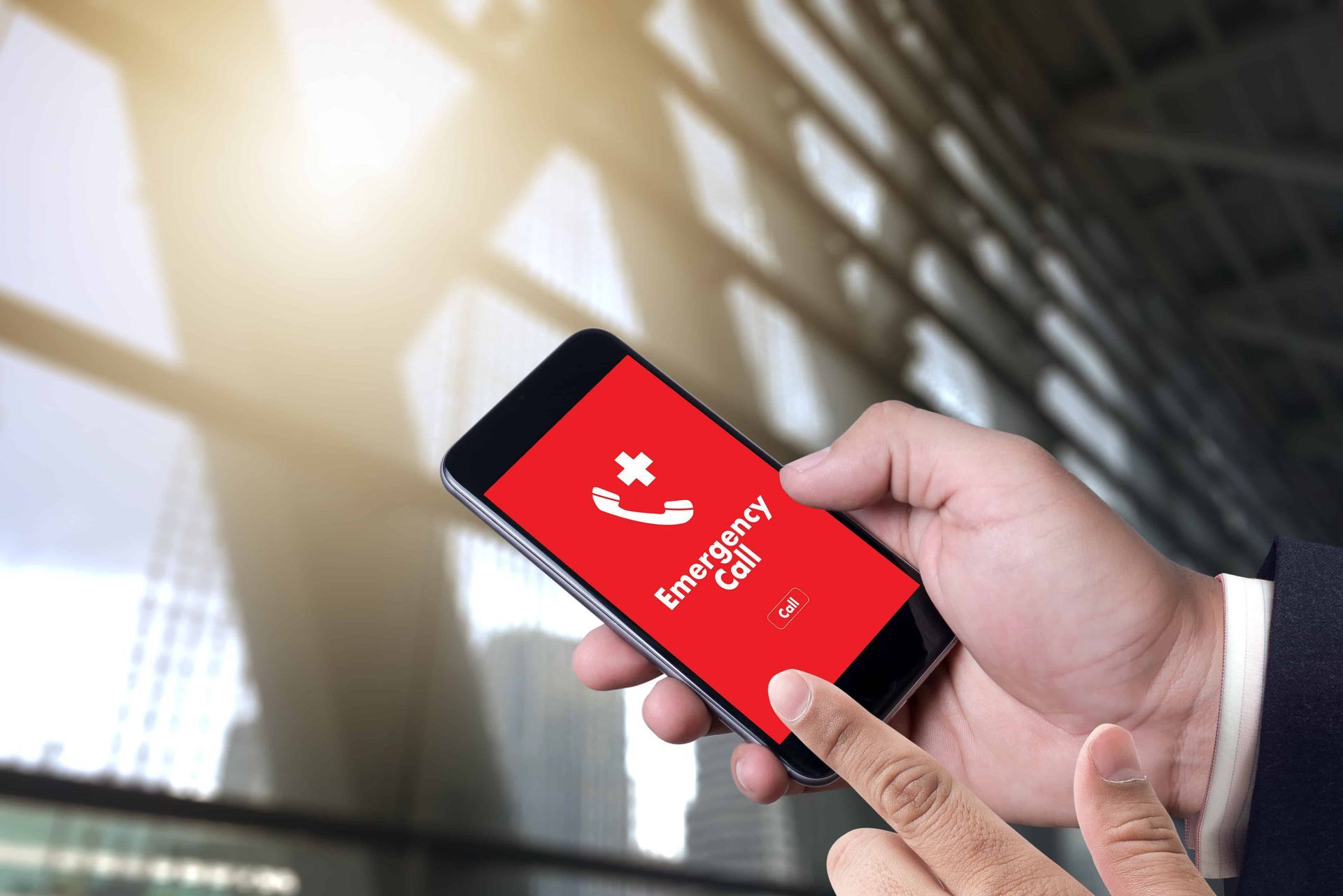 A man making an emergency phone call on a cell phone