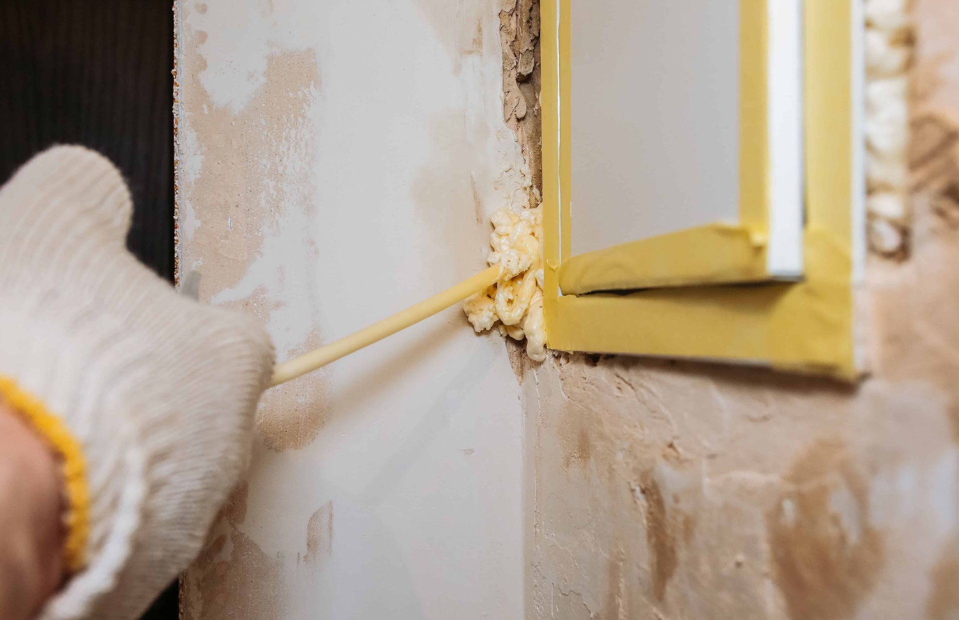 A person installing insulation to a door