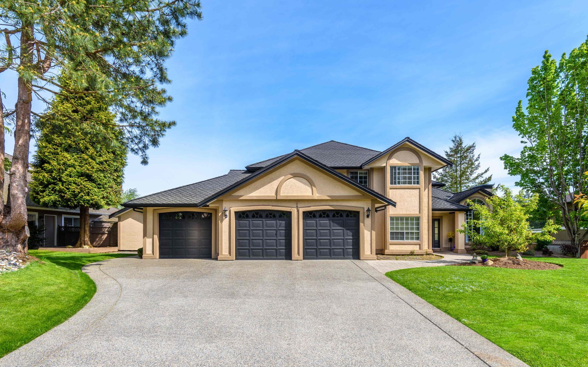A large house with nice new garage doors on the garage