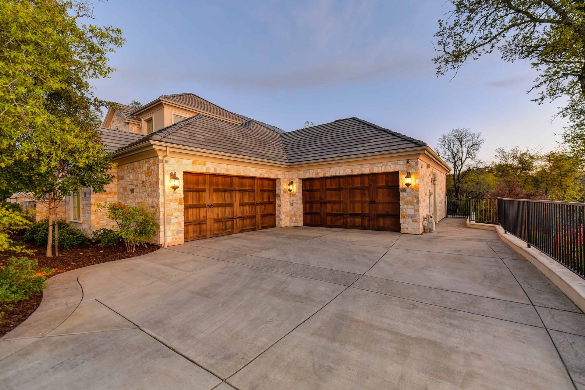 A nice, big house with two brown garage doors on the outside