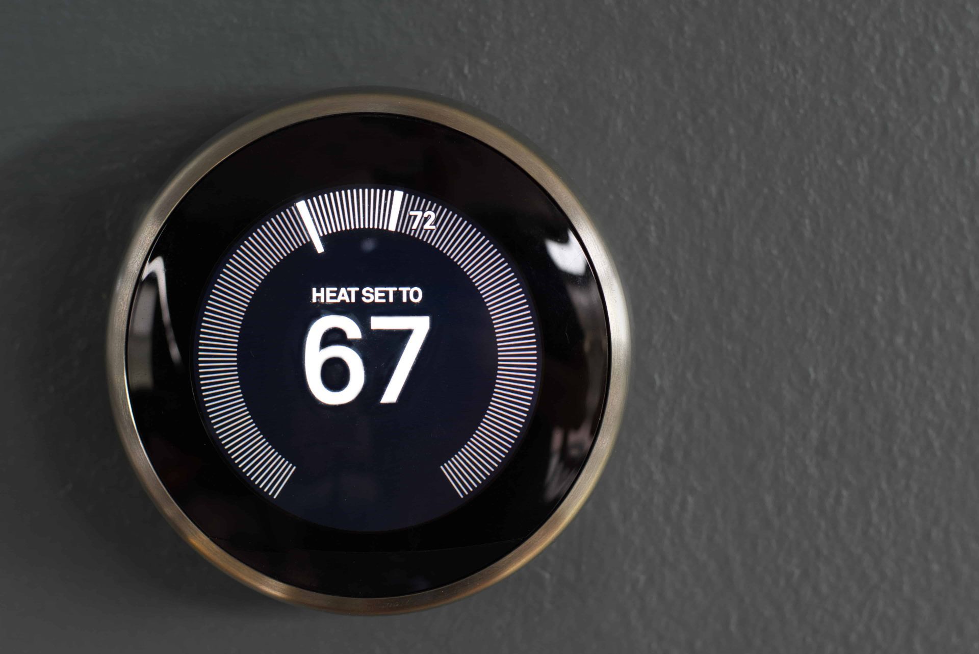 A thermostat set to 67 degrees