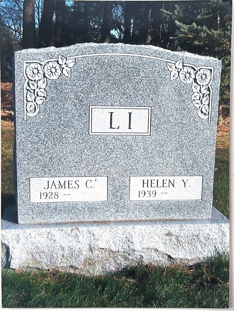 Gray granite memorial gravestone with ornate corners and the letters “LI” centered.